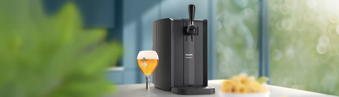 Philips Draft Beer Appliance serving fresh draft beer in a modern home kitchen. Philips Draft Beer Appliance serving fresh draft beer in a modern home kitchen.