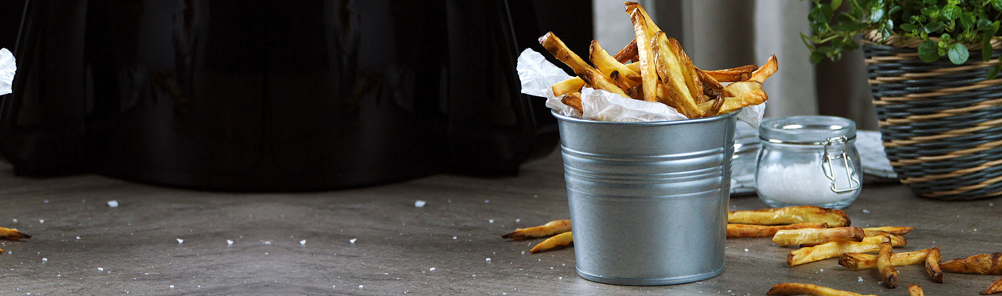 Air-fried potatoes served in a tin box, sprinkled with salt, and ready to be enjoyed. Air-fried potatoes served in a tin box, sprinkled with salt, and ready to be enjoyed.