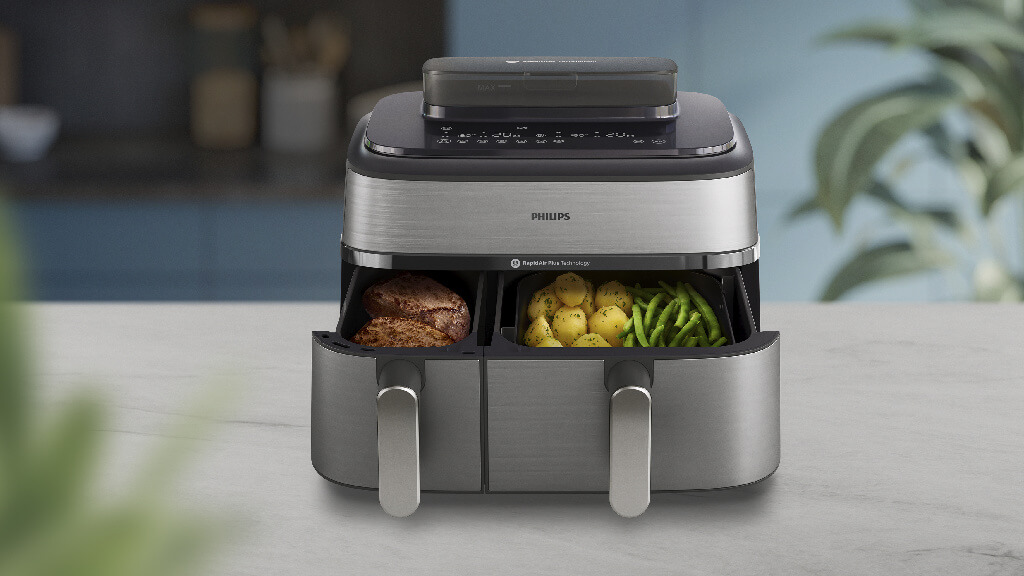 Frytkownica Philips ze stali nierdzewnej z warzywami i mięsem w środku Frytkownica Philips ze stali nierdzewnej z warzywami i mięsem w środku