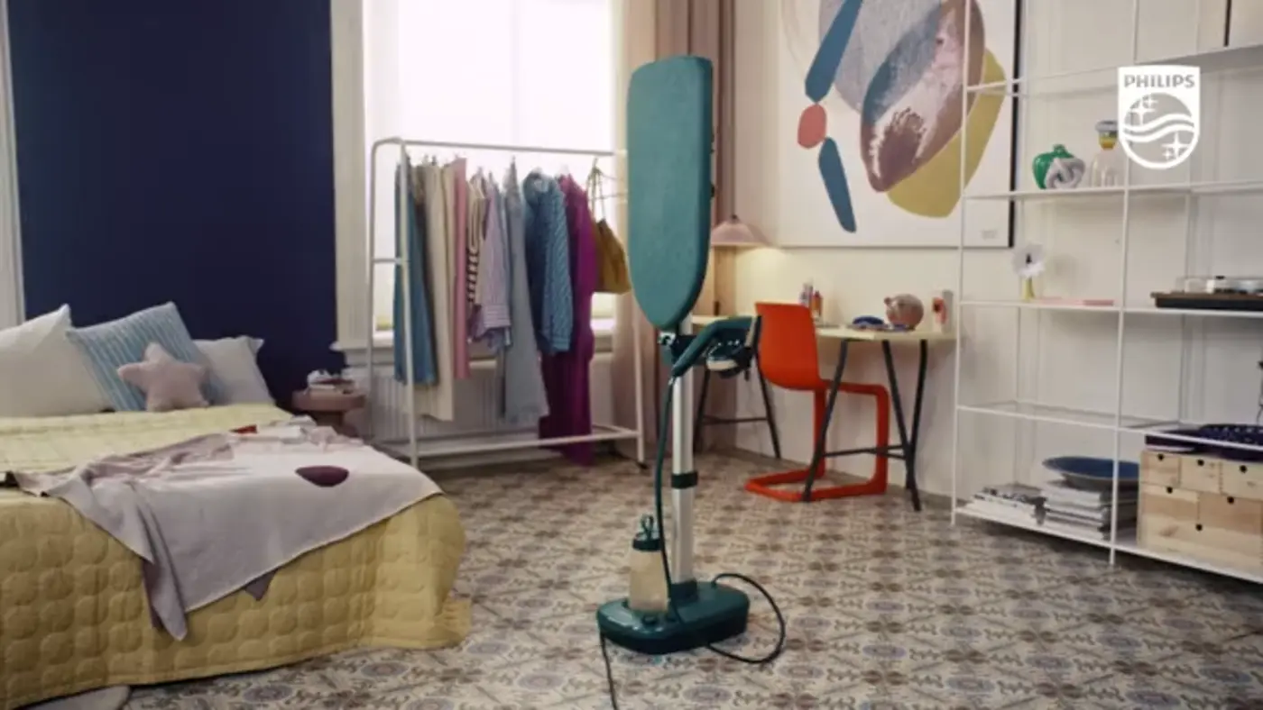 Philips All-in-One Garment Care solution; premium steamer featuring integrated board, designed for effortless crease removal. Modern room setting. Philips All-in-One Garment Care solution; premium steamer featuring integrated board, designed for effortless crease removal. Modern room setting.