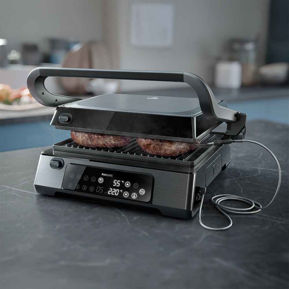 Närbild av en Philips grill & brödrost modell som pressar hamburgare. Digital display, temperaturmätare och non-stick beläggning framhäver denna premiumgrill. Närbild av en Philips grill & brödrost modell som pressar hamburgare. Digital display, temperaturmätare och non-stick beläggning framhäver denna premiumgrill.