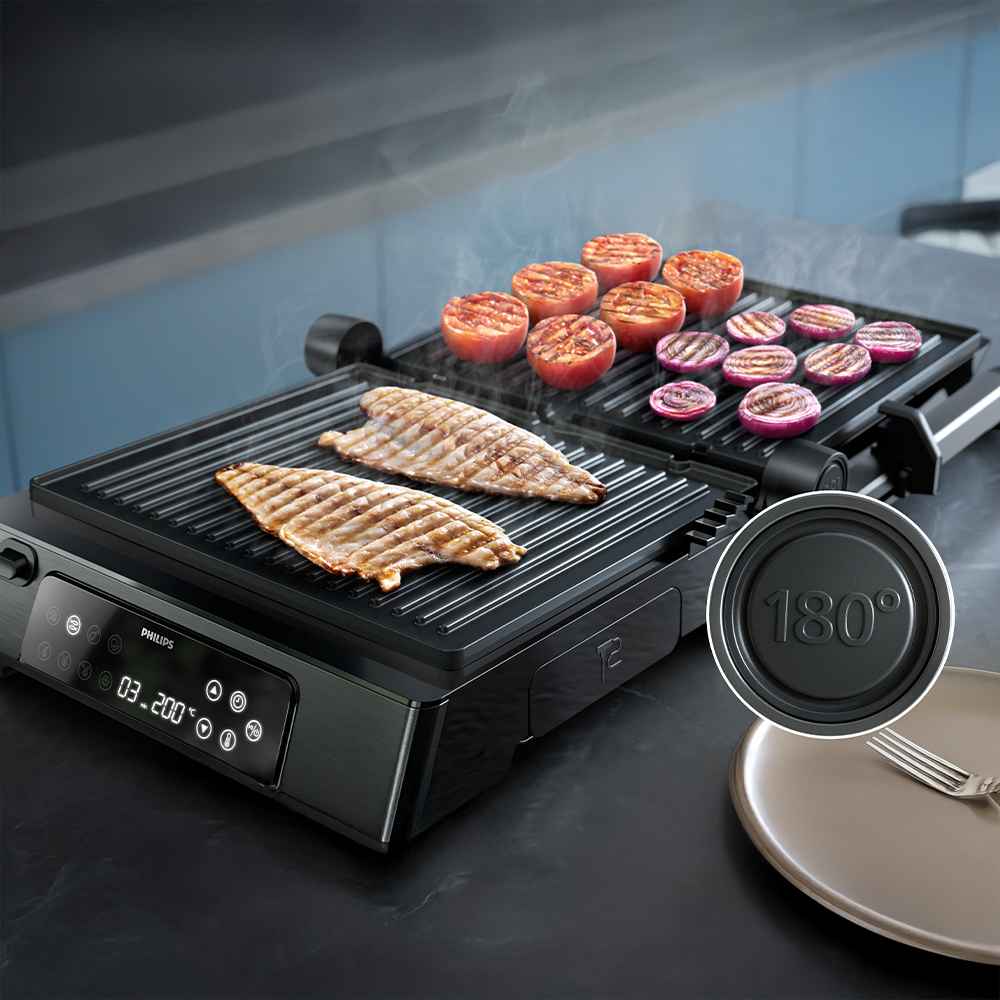 Philipsin Grills & leivänpaahtimet -mallisto: avoin sähkögrilli esittelee kalaa, tomaattia ja sipulia. Digitaalinen näyttö korostaa lämpötilan säätöä ja monipuolisuutta. Philipsin Grills & leivänpaahtimet -mallisto: avoin sähkögrilli esittelee kalaa, tomaattia ja sipulia. Digitaalinen näyttö korostaa lämpötilan säätöä ja monipuolisuutta.