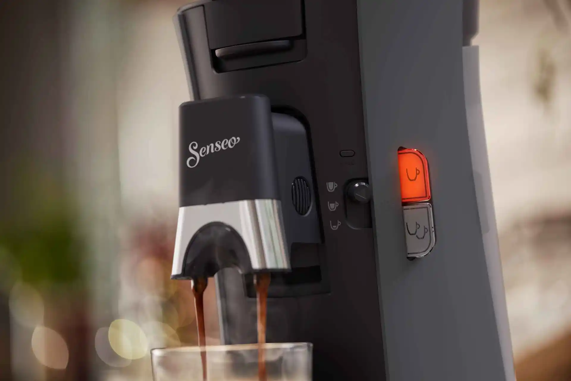 Close-up of a Philips Senseo coffee machine dispensing coffee, showcasing its stylish design, ease of use with single-serve pods, and superior coffee extraction for optimal taste. Close-up of a Philips Senseo coffee machine dispensing coffee, showcasing its stylish design, ease of use with single-serve pods, and superior coffee extraction for optimal taste.
