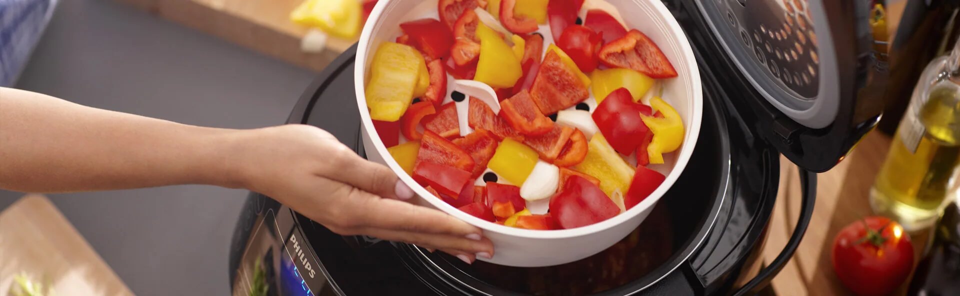 O persoană ține un bol cu mâncare în fața unui multicooker, pregătindu-se pentru gătitul lent. O persoană ține un bol cu mâncare în fața unui multicooker, pregătindu-se pentru gătitul lent.