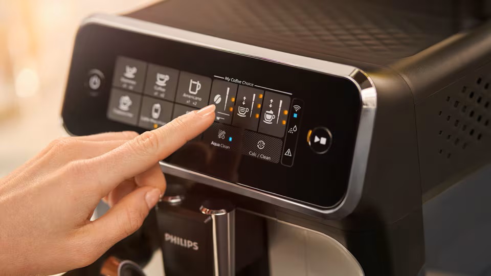 Finger selecting an option on an automatic coffee machine. Finger selecting an option on an automatic coffee machine.