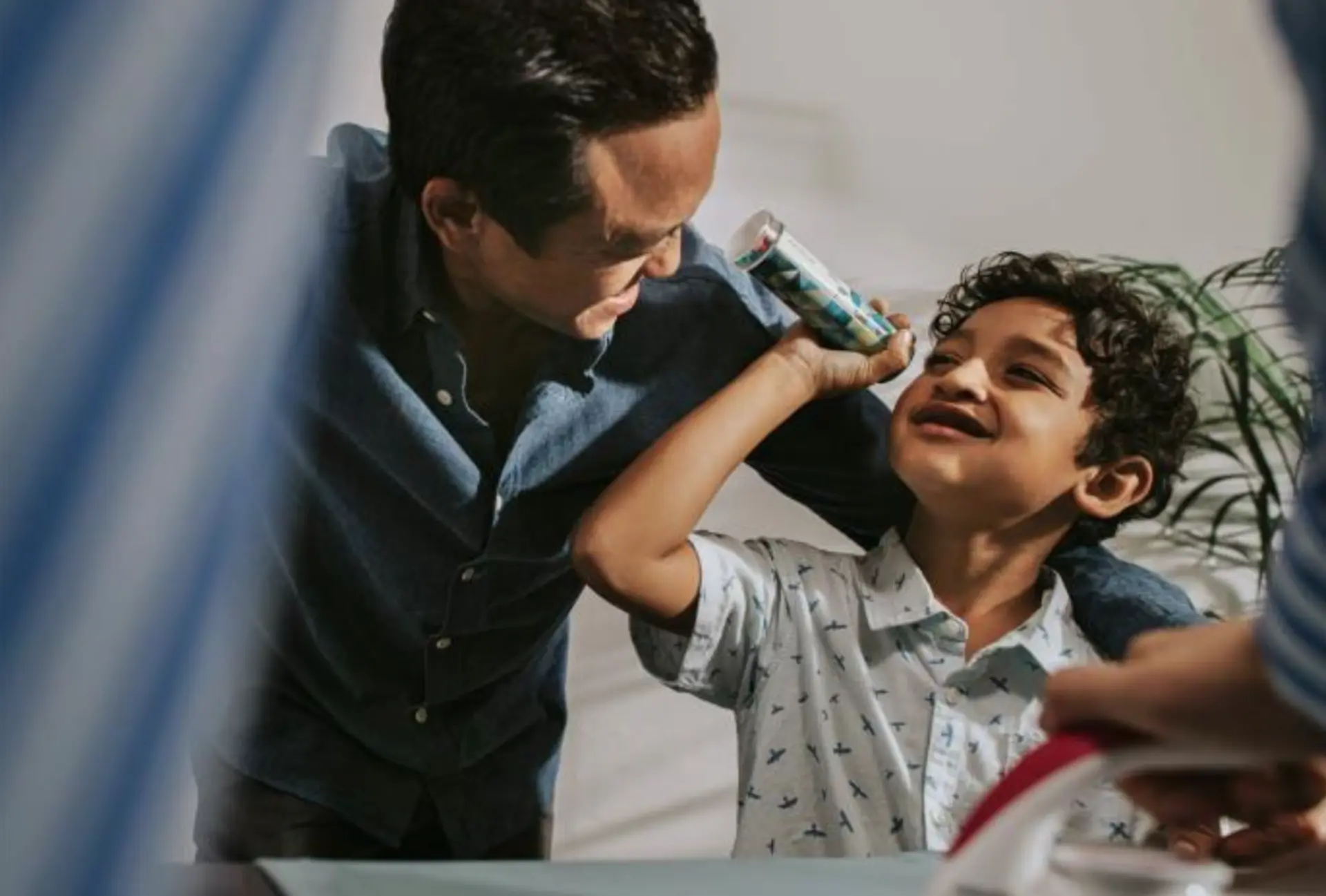 Man and his child playing together with a toy Man and his child playing together with a toy