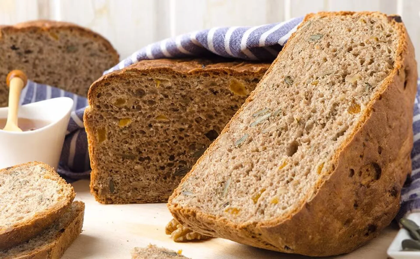 A loaf of rye nut fitness bread placed on a table A loaf of rye nut fitness bread placed on a table