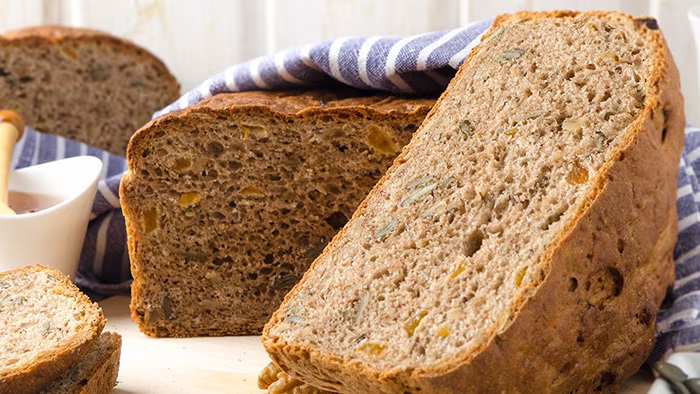 A loaf of rye nut fitness bread on a table. A loaf of rye nut fitness bread on a table.
