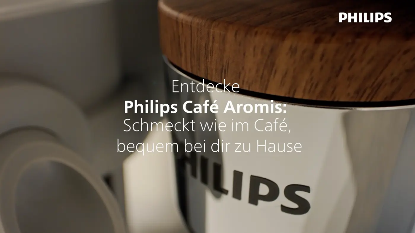 Nahaufnahme der vollautomatischen Philips 8000 LatteGo Pro Café Aromis Espressomaschine mit Holzfinish und Philips-Logo, die Kaffee in Café-Qualität bewirbt. Nahaufnahme der vollautomatischen Philips 8000 LatteGo Pro Café Aromis Espressomaschine mit Holzfinish und Philips-Logo, die Kaffee in Café-Qualität bewirbt.